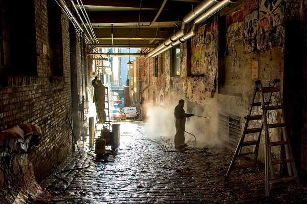 Clean interior brick with pressure washer